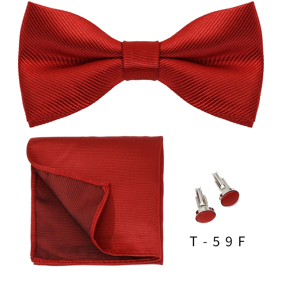 A red satin bow tie and cufflink set displayed against a white background.