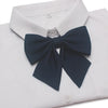 White dress shirt with a navy blue butterfly ribbon tie neatly tied at the collar