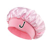 Pink satin hair cap with a black letter J print on the front