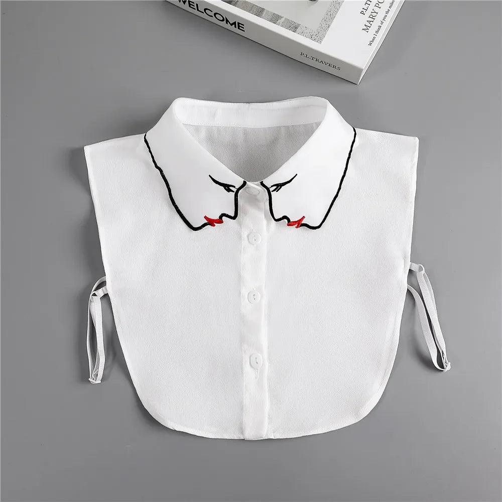 White blouse with a fashionable false collar neckline featuring black and red accents.