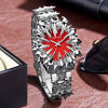 Silver watch with dragon scale design and red dial resting on a brown leather surface.