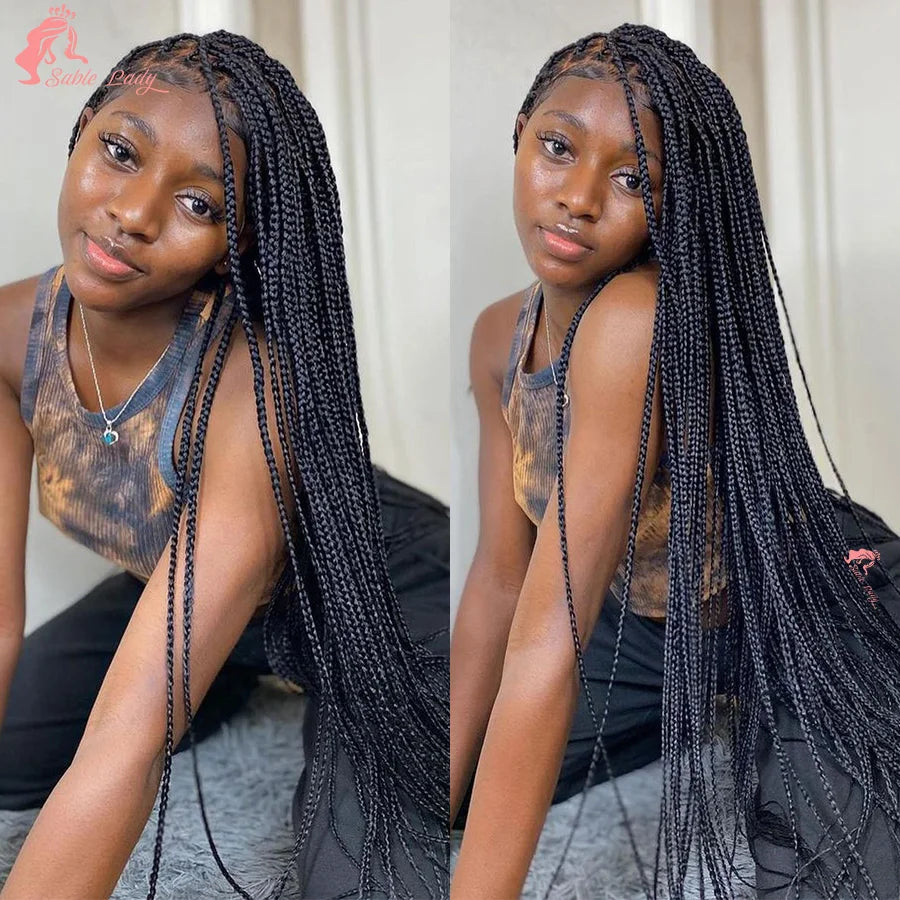 A woman modeling a 36 inch full lace box braids wig with long black dreadlocks.