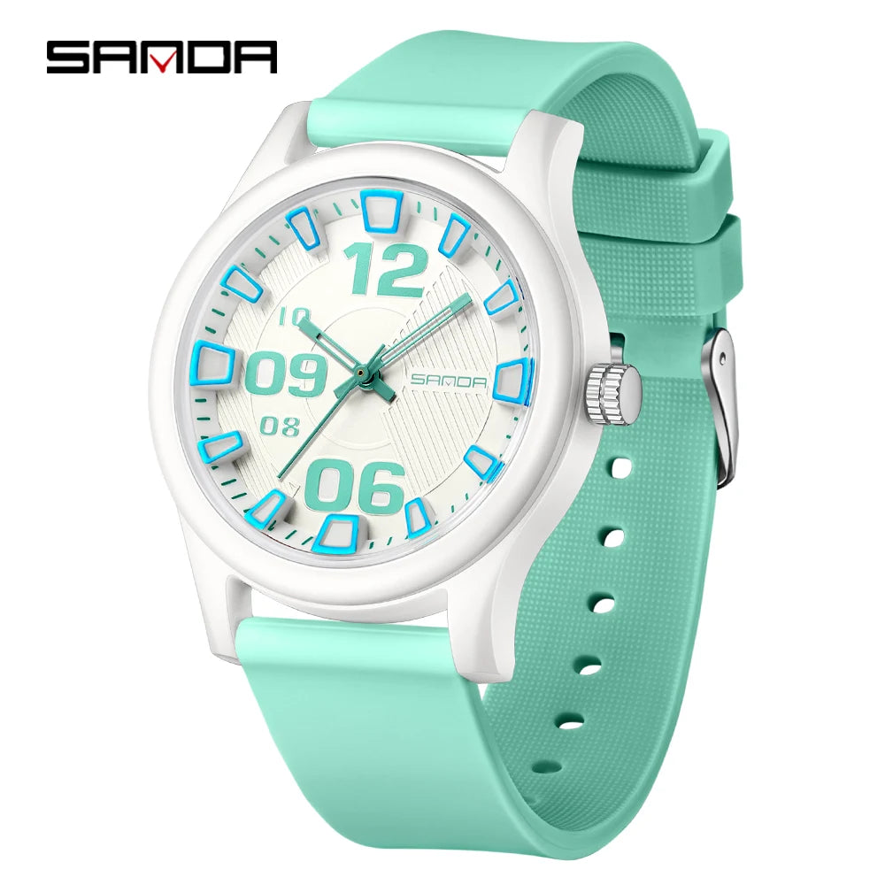 A white and teal digital watch with a light green silicone strap shown against a white background.