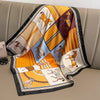 A silk scarf and headband set featuring a pattern of stylized horses and geometric designs in yellow, orange, brown, and blue