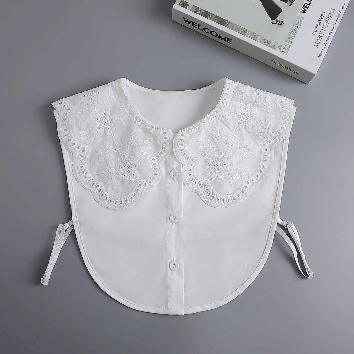 White blouse with a decorative lace false collar and detachable necklines