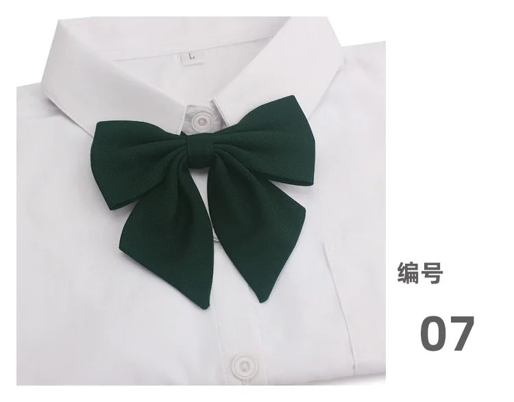 A white collared shirt with a dark green butterfly ribbon tie set on the chest.