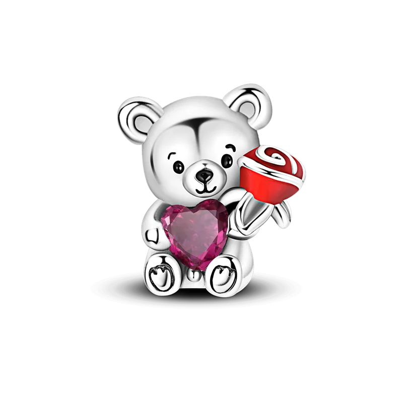 A silver teddy bear charm holding a red and white candy, set against a black background.