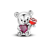 A sterling silver teddy bear charm holding a red and white candy-themed object.