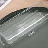 A clear plastic jewelry storage pouch with measurements and a gold bracelet shown on a dark surface.