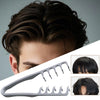 A gray volume boosting detangling hair comb shown next to a styled dark hairstyle.