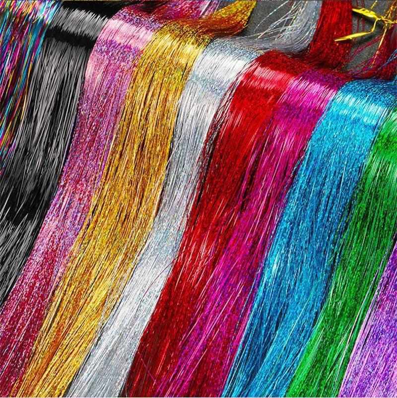 A close-up display of various rainbow glitter hair extensions in vibrant colors like pink, gold, silver, red, blue, and green