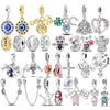 Sterling silver devil's eye charm bracelet featuring various charms and pendants
