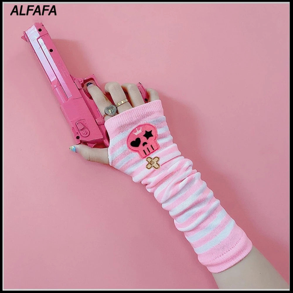 A hand wearing a pink fingerless sleeve holds a pink handgun.