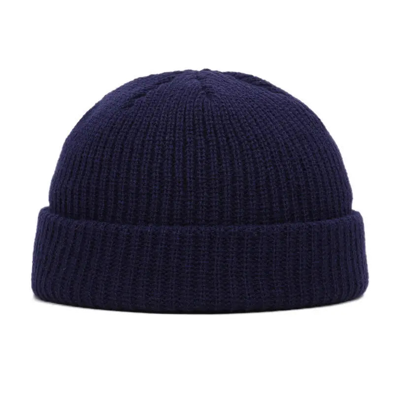 A dark navy blue knitted beanie cap shown from the front.