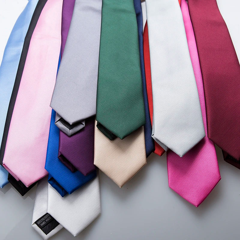 A collection of men's slim jacquard business ties in various shades of pink, blue, green, and purple.