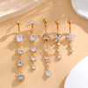 A set of five gold stainless steel dangled belly button rings featuring various diamond and pearl-like gemstone designs.