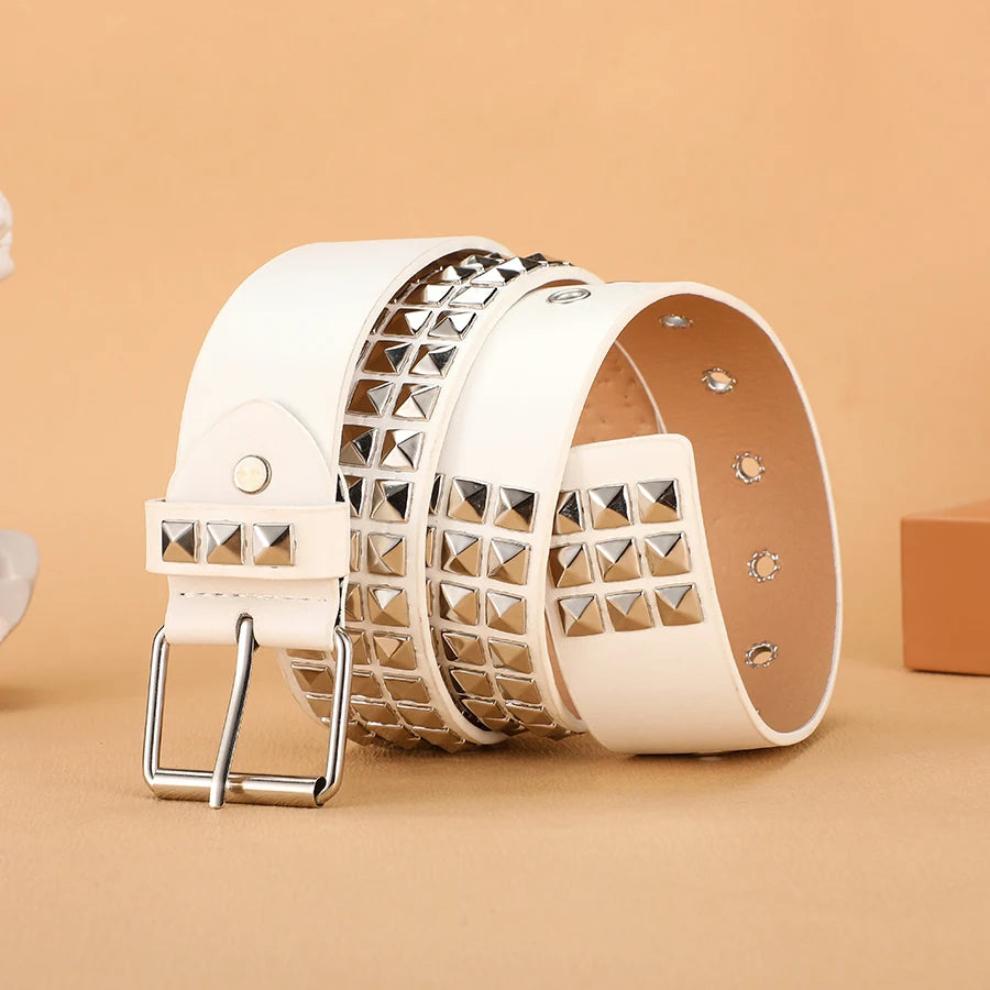 A white heavy metal riveted belt for men and women shown in a close-up view.