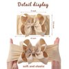 Detail display of a beige soft elastic headband with a chunky hair bow.