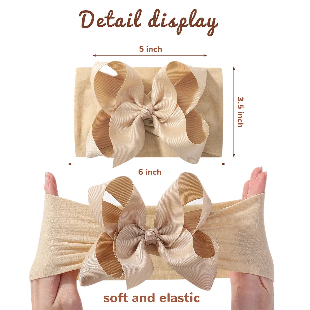 Detail display of a beige soft elastic headband with a chunky hair bow.