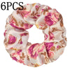 Un set de seis penyos de satén con estampado floral en tonos rosa y beige para el cabello.