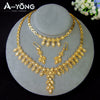 A gold plated bridal jewelry set featuring layered necklaces and earrings displayed on a gray stand.