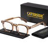 A pair of tortoiseshell retro square anti-blue light eyeglasses resting on a black cloth next to a black box.