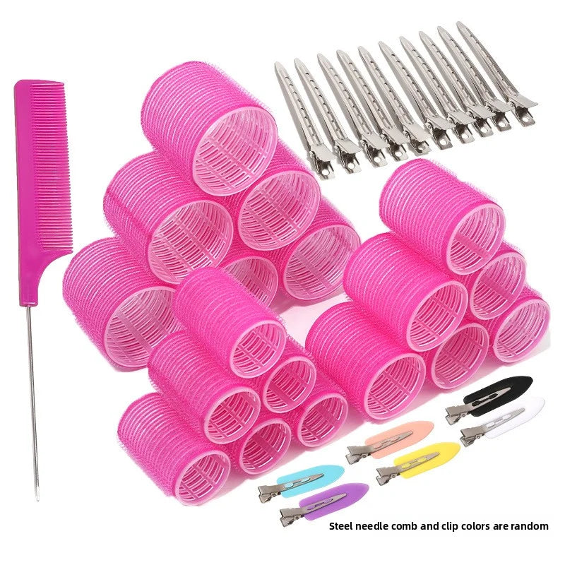 A set of pink heatless hair curlers and clips with various metal tips for DIY styling.