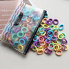 A collection of colorful elastic hair bands in various shades of pink, yellow, green, and purple are displayed next to a clea