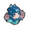 A cute anime character brooch featuring a girl with blue hair and pink flowers.