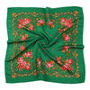 A vibrant green silk scarf featuring an intricate floral print with shades of pink, red, and orange.