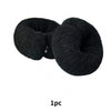 A black elastic hair bun tool made of gauze is shown in a close-up view.
