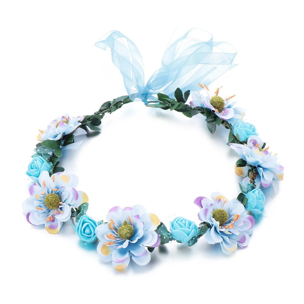 A bohemian flower headband featuring light blue and purple flowers and sheer blue ribbon.