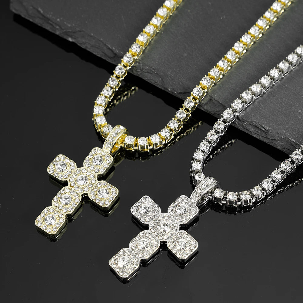 A close-up of a sparkling rhinestone cross pendant necklace displayed on a dark surface.