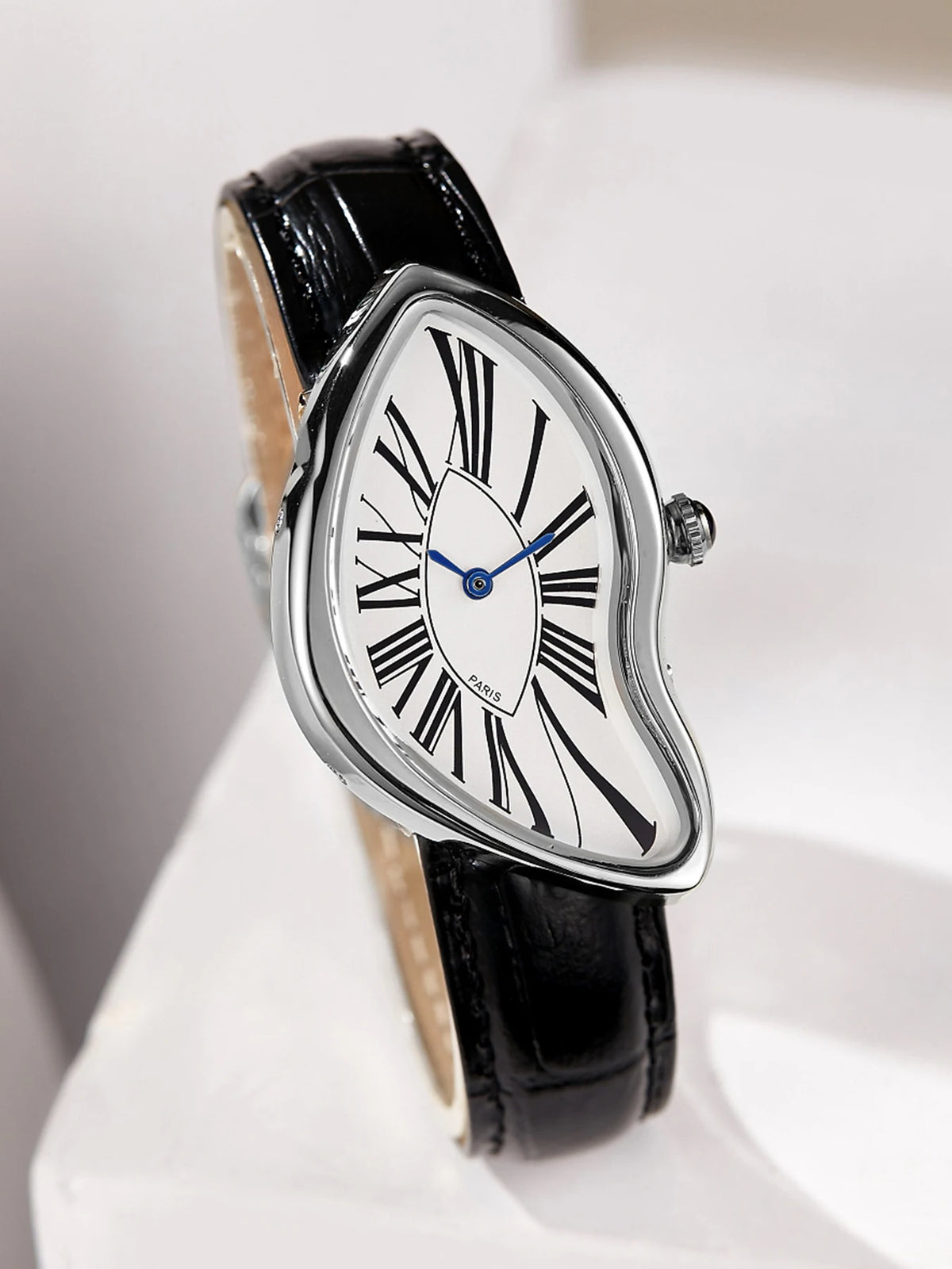 A silver-cased fashion quartz wristwatch with a white dial, Roman numerals, and a black leather strap.