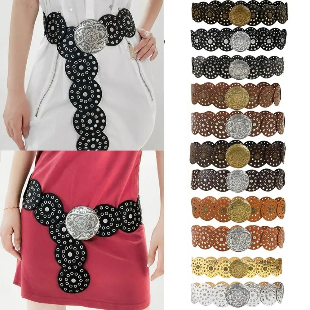 A close-up of vintage PU disc belts with metal buckles in black, silver, and gold tones.