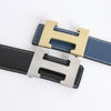A close-up of a genuine leather dress belt for jeans featuring two buckles, one gold and one silver.