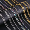 A collection of gold and silver stainless steel Cuban link necklaces displayed on a black leather surface.