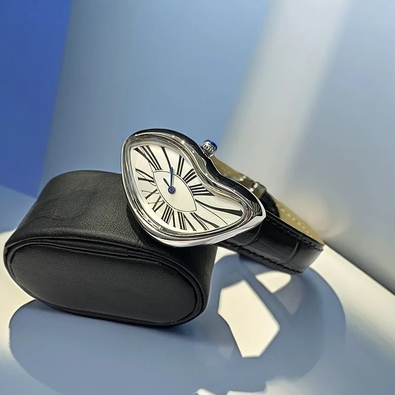 A silver-cased fashion quartz wristwatch with a Roman dial and leather strap resting on a black leather pouch.