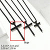 A set of black stainless steel cross pendant necklaces displayed on a white surface.