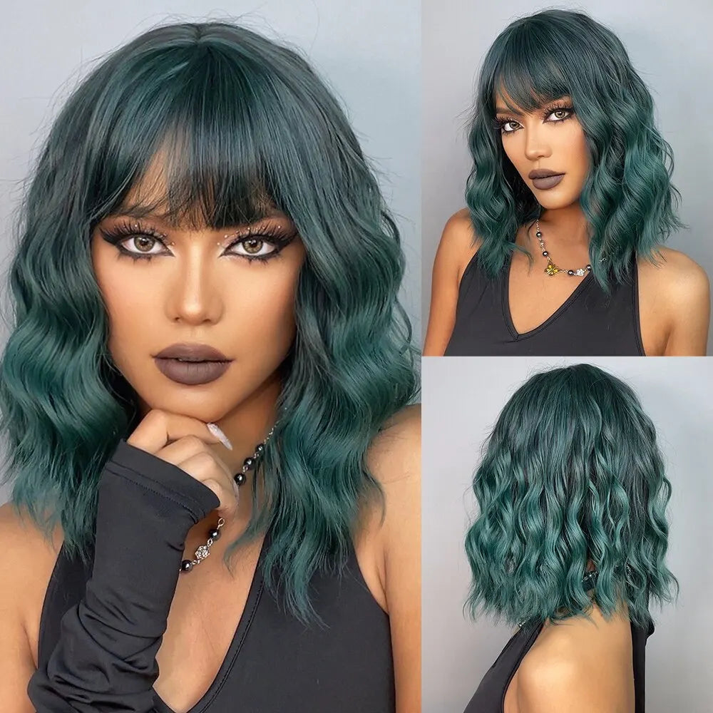 A woman models a teal short wavy bob wig with bangs in a black top.