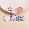 A set of five enamel pins featuring funny quotes on a light pink background.