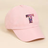 A pink baseball cap featuring a purple and white unicorn letter embroidered on the front.
