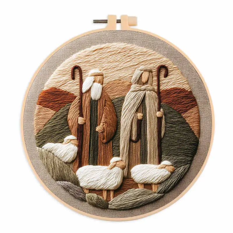 A circular embroidery design featuring a shepherd and sheep in earthy tones on a natural fabric background.