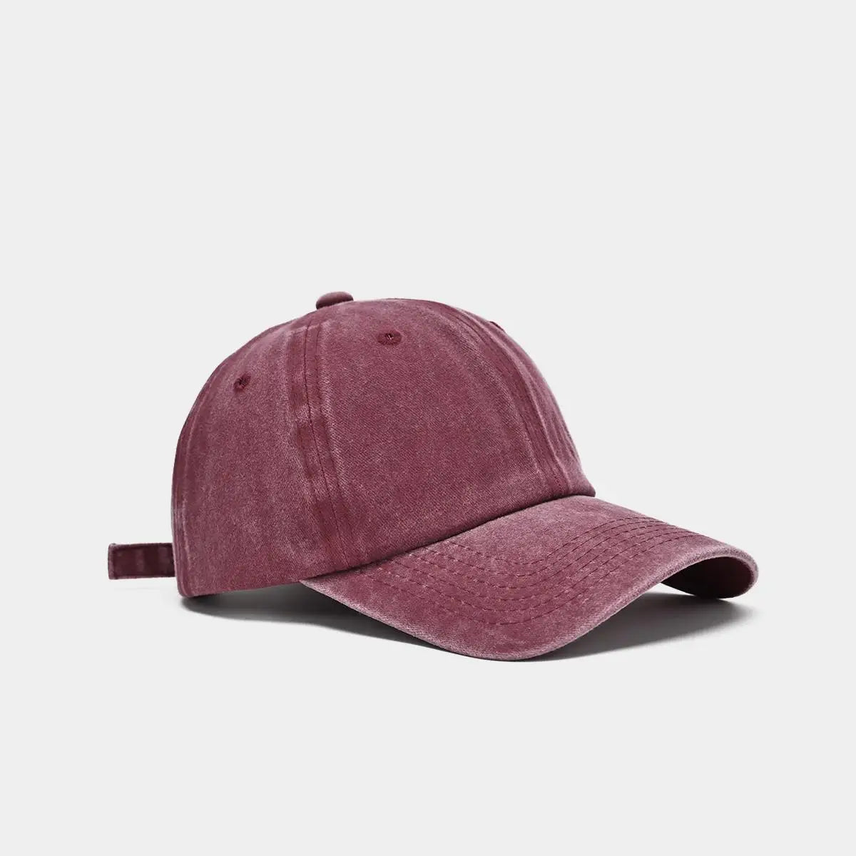 A maroon washed cotton snapback cap shown from the side.