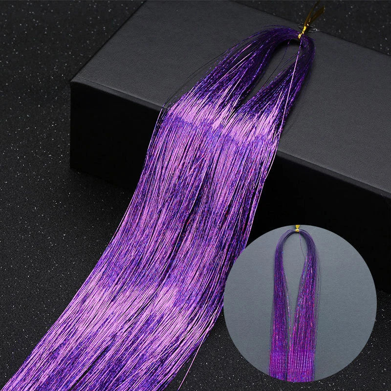 Purple glitter hair extensions strands displayed against a dark background.