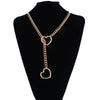 A gold-toned heart slip chain necklace displayed on a black velvet display stand.