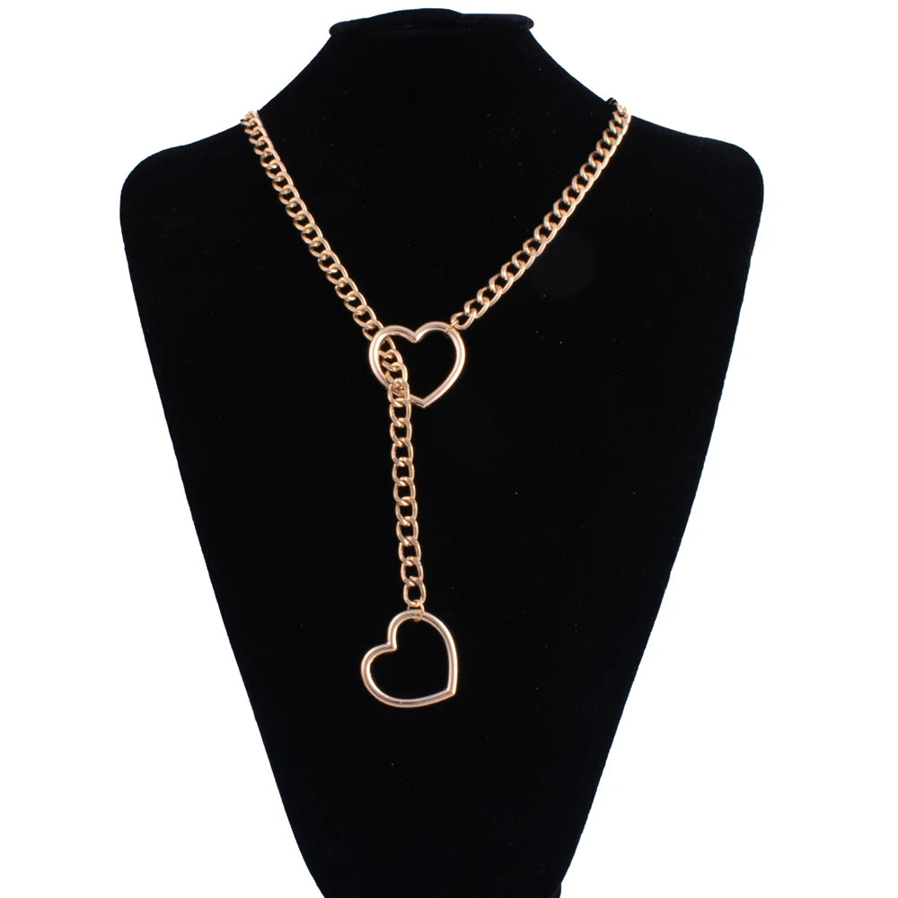 A gold-toned heart slip chain necklace displayed on a black velvet display stand.