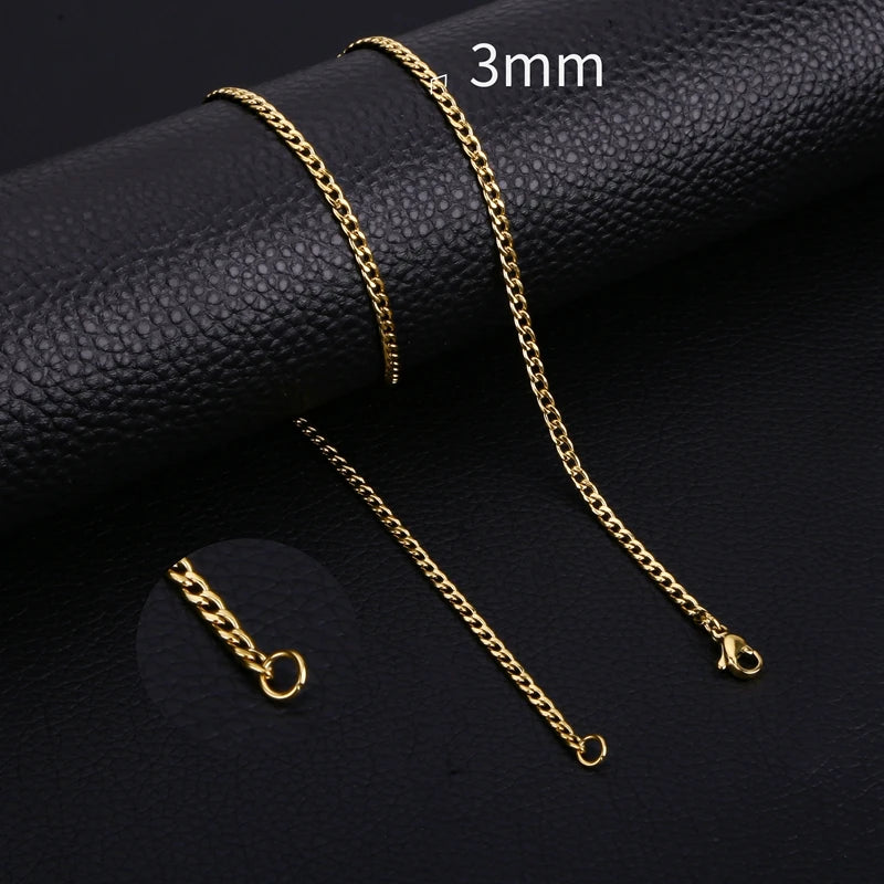 Three gold-colored stainless steel Cuban link necklaces displayed on a black leather background.