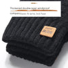 Gants d'hiver noirs tricotés avec détail de boussole et poignet élastique.
