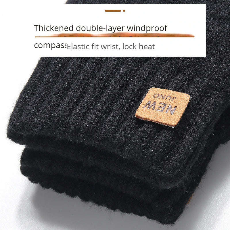 Gants d'hiver noirs tricotés avec détail de boussole et poignet élastique.